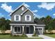 Charming two-story home boasts beautiful gray siding, white trim, and a covered front porch at 121 Restful Point, Fuquay Varina, NC 27526