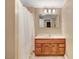 Bathroom features a wood vanity with ample storage, and a shower with neutral tile at 125 W Pine St, Pine Level, NC 27568