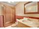 Bathroom with a sink, wooden storage cabinet, and a mirror on the wall with patterned wallpaper at 125 W Pine St, Pine Level, NC 27568