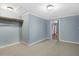 Bright bedroom features neutral carpet, blue walls, white trim, and closet with ample storage at 125 W Pine St, Pine Level, NC 27568