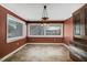 Cozy dining room with tiled floors, large windows, and a classic chandelier with wood trim at 125 W Pine St, Pine Level, NC 27568