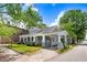 Inviting home exterior featuring a classic covered porch, manicured lawn, and blossoming flowers adding to its curb appeal at 125 W Pine St, Pine Level, NC 27568
