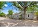Side view of a charming home featuring a covered porch, lush green lawn, and mature trees at 125 W Pine St, Pine Level, NC 27568
