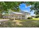 Exterior view showcasing a two-story home with a convenient carport, multi-car garage, and a sprawling green lawn at 125 W Pine St, Pine Level, NC 27568