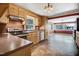 Functional kitchen with wood cabinets, stainless steel appliances, and tile floors, with an adjacent dining area at 125 W Pine St, Pine Level, NC 27568