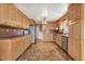 Spacious kitchen featuring wood cabinets, tile floors, and stainless steel appliances at 125 W Pine St, Pine Level, NC 27568