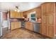 Charming kitchen with wood cabinets, stainless steel appliances, and light tile floors at 125 W Pine St, Pine Level, NC 27568