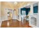 A classic living room featuring gleaming hardwood floors, decorative columns, and stylish built-ins at 125 W Pine St, Pine Level, NC 27568