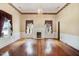 Bright living room with hardwood floors, fireplace, large windows, and decorative crown molding at 125 W Pine St, Pine Level, NC 27568