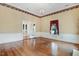 Sunlit living room featuring hardwood floors, large windows, and access to another room through french doors at 125 W Pine St, Pine Level, NC 27568