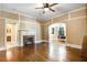 Living room featuring hardwood floors, a fireplace, and paneled walls for a touch of traditional elegance at 125 W Pine St, Pine Level, NC 27568