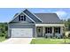 Charming two-story home featuring a two-car garage, attractive color scheme and inviting front porch at 131 Fish Camp Dr, Wendell, NC 27591