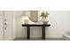 Elegant entryway featuring a stylish console table, a decorative mirror, and contemporary lighting at 1416 Jay Rd, Knightdale, NC 27545