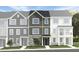 New townhome featuring three stories, Hardie siding, stone accents, and individual entryways at 1420 Jay Rd, Knightdale, NC 27545