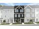 Charming townhome showcasing a dark-colored exterior, complemented by stone accents, and a well-manicured lawn at 1422 Jay Rd, Knightdale, NC 27545