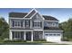 Charming two-story home features a stone facade, gray siding, and a two-car garage at 1625 Goldfinch Perch Ln, Knightdale, NC 27545