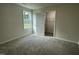 This bedroom has neutral walls, carpet and a closet with shelving, offering a calming and organized space at 175 Oakfield Trace Dr, Four Oaks, NC 27524