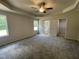 Large bedroom with carpet, a ceiling fan, two windows and access to a closet and bathroom, perfect for relaxation at 175 Oakfield Trace Dr, Four Oaks, NC 27524