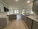Well-lit kitchen with stainless steel appliances, tile backsplash, granite counters, and open-concept layout at 175 Oakfield Trace Dr, Four Oaks, NC 27524