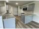 Modern kitchen with granite countertops, wood-look flooring, gray cabinets, and stainless steel microwave at 175 Oakfield Trace Dr, Four Oaks, NC 27524