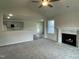 Spacious living room featuring a fireplace and an open-concept view of the eat-in kitchen area at 175 Oakfield Trace Dr, Four Oaks, NC 27524