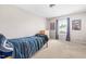 Bedroom with neutral carpet, a twin bed, blue bedding, and a bright window at 2011 Unbridled Dr, Knightdale, NC 27545
