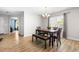 Bright dining room featuring modern flooring and an elegant chandelier at 2011 Unbridled Dr, Knightdale, NC 27545