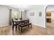 Bright dining room features stylish chandelier, wood floors, and neutral paint at 2011 Unbridled Dr, Knightdale, NC 27545