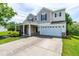 Two-story home featuring a two-car garage, a welcoming porch, and a well-maintained lawn and driveway at 2011 Unbridled Dr, Knightdale, NC 27545