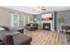 Cozy living room featuring a fireplace, large windows, and stylish, neutral decor at 2011 Unbridled Dr, Knightdale, NC 27545