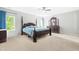 Spacious main bedroom featuring a four-poster bed and a dresser with a mirror at 2011 Unbridled Dr, Knightdale, NC 27545