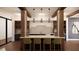 Stylish kitchen with modern lighting, breakfast bar with stools, stone backsplash, and contemporary design at 2201 W Cornwallis Rd # 1B-1, Durham, NC 27705