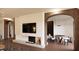 Living room features modern fireplace with marble hearth, TV, archway, and dining table and chairs at 2201 W Cornwallis Rd # 2B-3, Durham, NC 27705