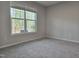 Bedroom features plush carpeting, natural light, and exterior views at 2203 Lambert Rd # 67, Cary, NC 27519