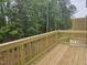 A wood deck with wood railings overlooks a treed backyard on this lovely home at 2203 Lambert Rd # 67, Cary, NC 27519