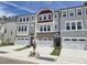 View of new construction townhomes featuring attached garages and neutral toned exteriors at 2203 Lambert Rd # 67, Cary, NC 27519
