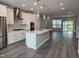 Spacious kitchen flows to living space with island, pendant lighting, and stainless appliances at 2203 Lambert Rd # 67, Cary, NC 27519