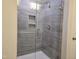 A close up of a shower featuring modern fixtures and gray tile at 2203 Lambert Rd # 67, Cary, NC 27519