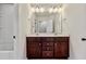 Bathroom featuring a double sink vanity, white walls, and a large mirror with modern light fixtures at 226 Begen St, Morrisville, NC 27560