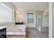 Bright bathroom features a soaking tub, glass-enclosed shower, tile floors and a double sink vanity at 226 Begen St, Morrisville, NC 27560