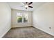 Neutral carpeted bedroom with ceiling fan and window providing natural light at 226 Begen St, Morrisville, NC 27560