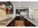 Modern kitchen with stainless steel appliances, granite countertops, and dark wood cabinetry at 226 Begen St, Morrisville, NC 27560