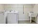 The laundry room boasts modern appliances, a utility sink, and ample shelving for storage at 226 Begen St, Morrisville, NC 27560