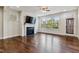 Bright living room featuring a fireplace, large windows, and hardwood floors at 226 Begen St, Morrisville, NC 27560