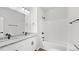 Modern bathroom featuring double sinks, granite countertops, and a shower-tub combo at 2305 Pinecroft Dv, Burlington, NC 27217