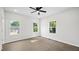 Neutral bedroom with three windows letting in natural light and a ceiling fan at 2305 Pinecroft Dv, Burlington, NC 27217