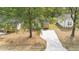 A beautifully landscaped home with a new driveway and well-manicured lawn at 2305 Pinecroft Dv, Burlington, NC 27217