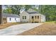 Charming home with a manicured lawn, a front porch, and a long driveway at 2305 Pinecroft Dv, Burlington, NC 27217