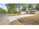 View of the home's exterior, landscaping, and front-facing driveway at 2305 Pinecroft Dv, Burlington, NC 27217
