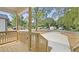 View of the front porch with wooden railing and the long driveway leading up to the home at 2305 Pinecroft Dv, Burlington, NC 27217